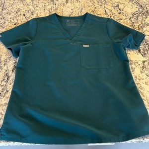 In great used condition Figs Carribean blue Catarina one pocket top. Medium